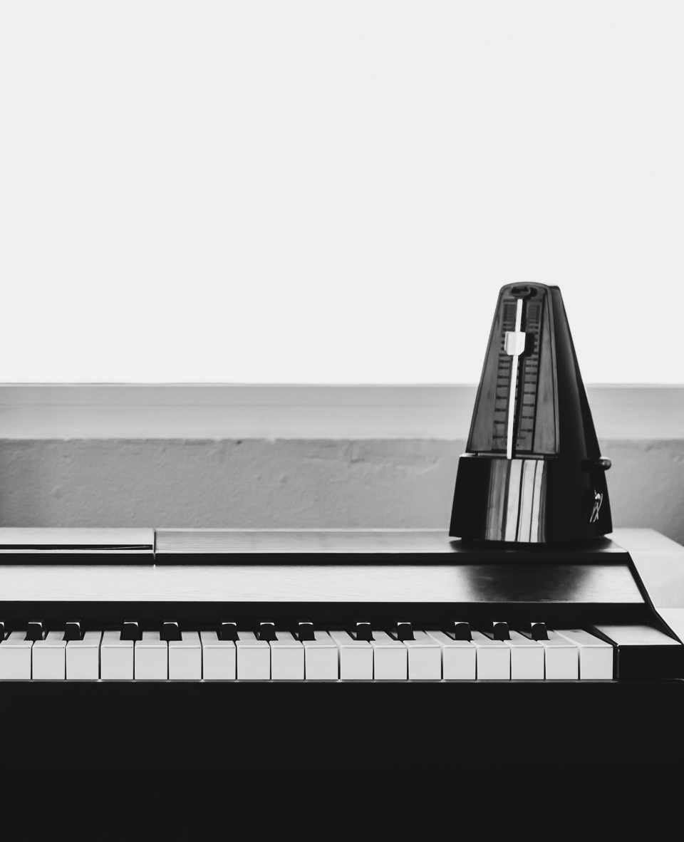 Piano with metronome. Music instrument. Art and abstract background in black and white theme with copy space.